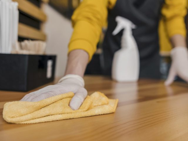 front-view-barista-cleaning-table